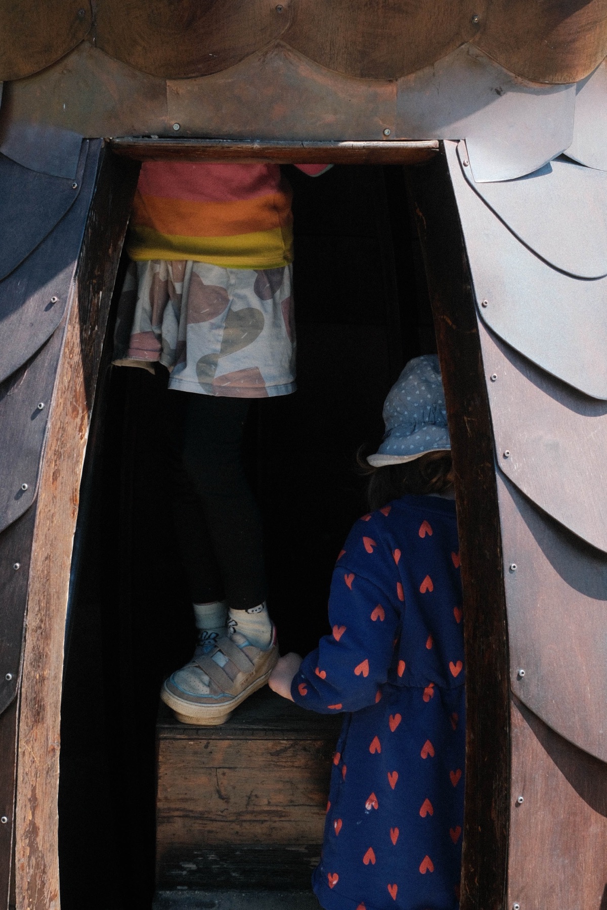 Colourful bags carried down a narrow stair