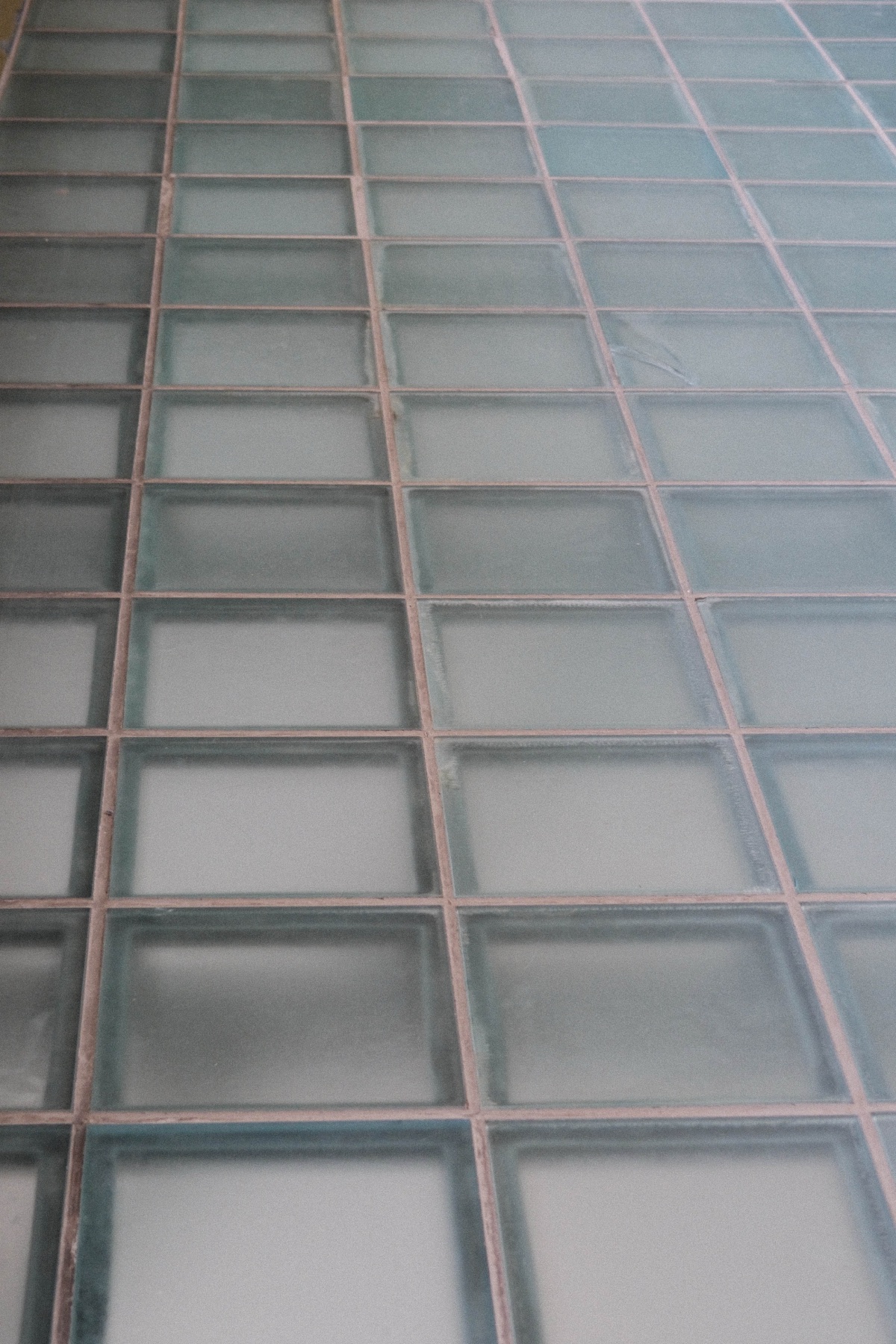 A pale grid of repeating glass façade panels