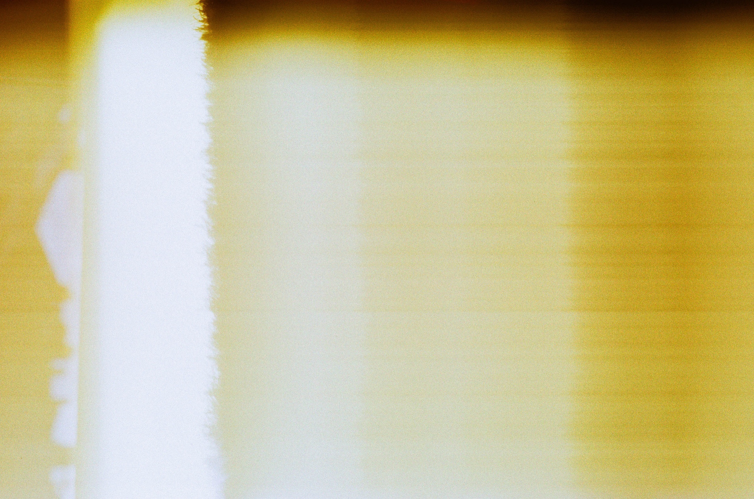 Abstract silhouettes passing through a wash of golden light