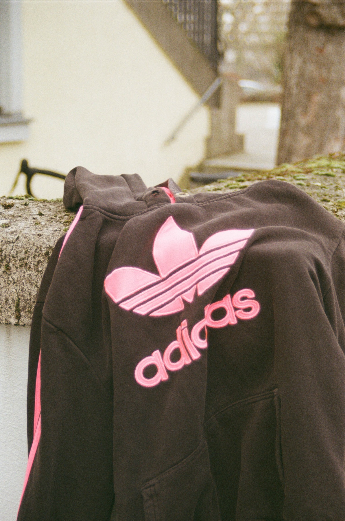 A black Adidas bag with a bright pink logo