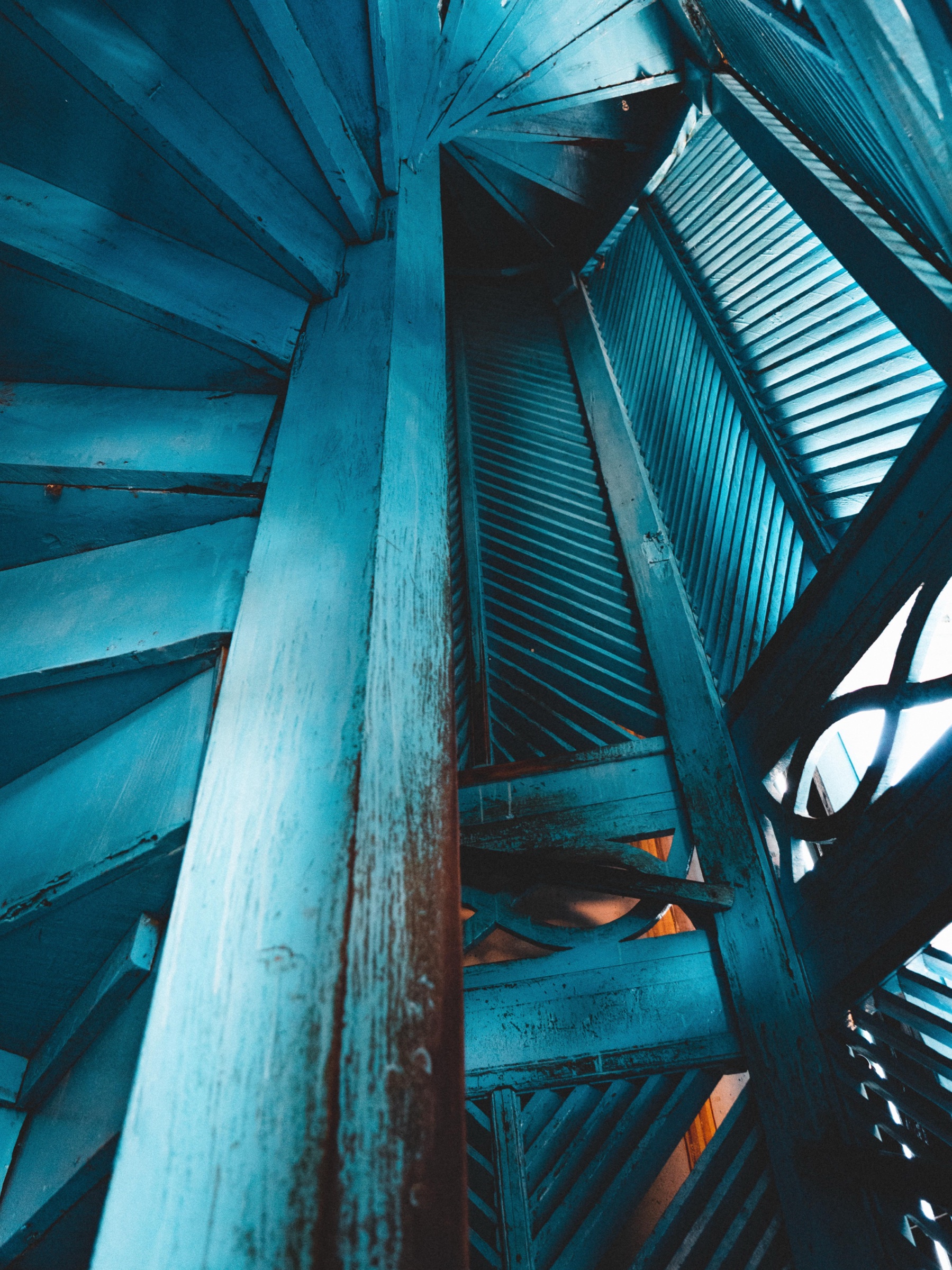 Blue architectural staircase rising through shadow and light