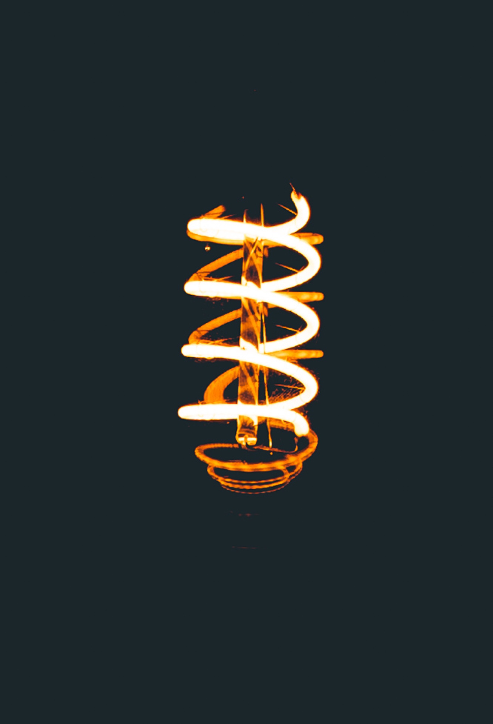 Orange spiral light glowing against a dark background