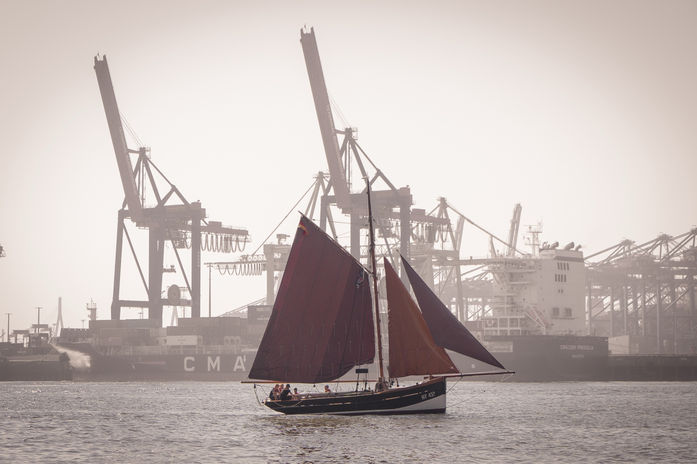 Traditional sailing ship crossing Hamburg harbour in soft light
