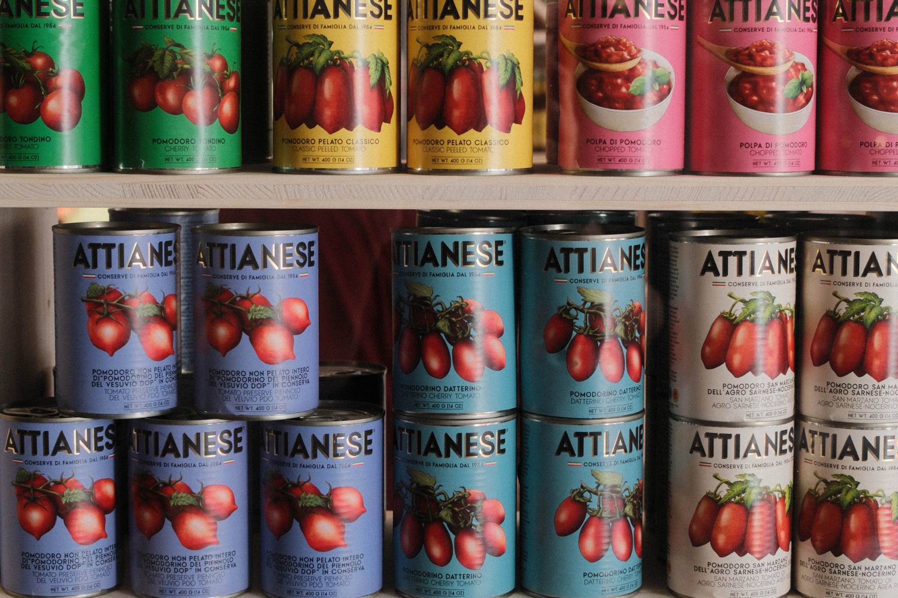 Rows of tomato cans in red, green and pink