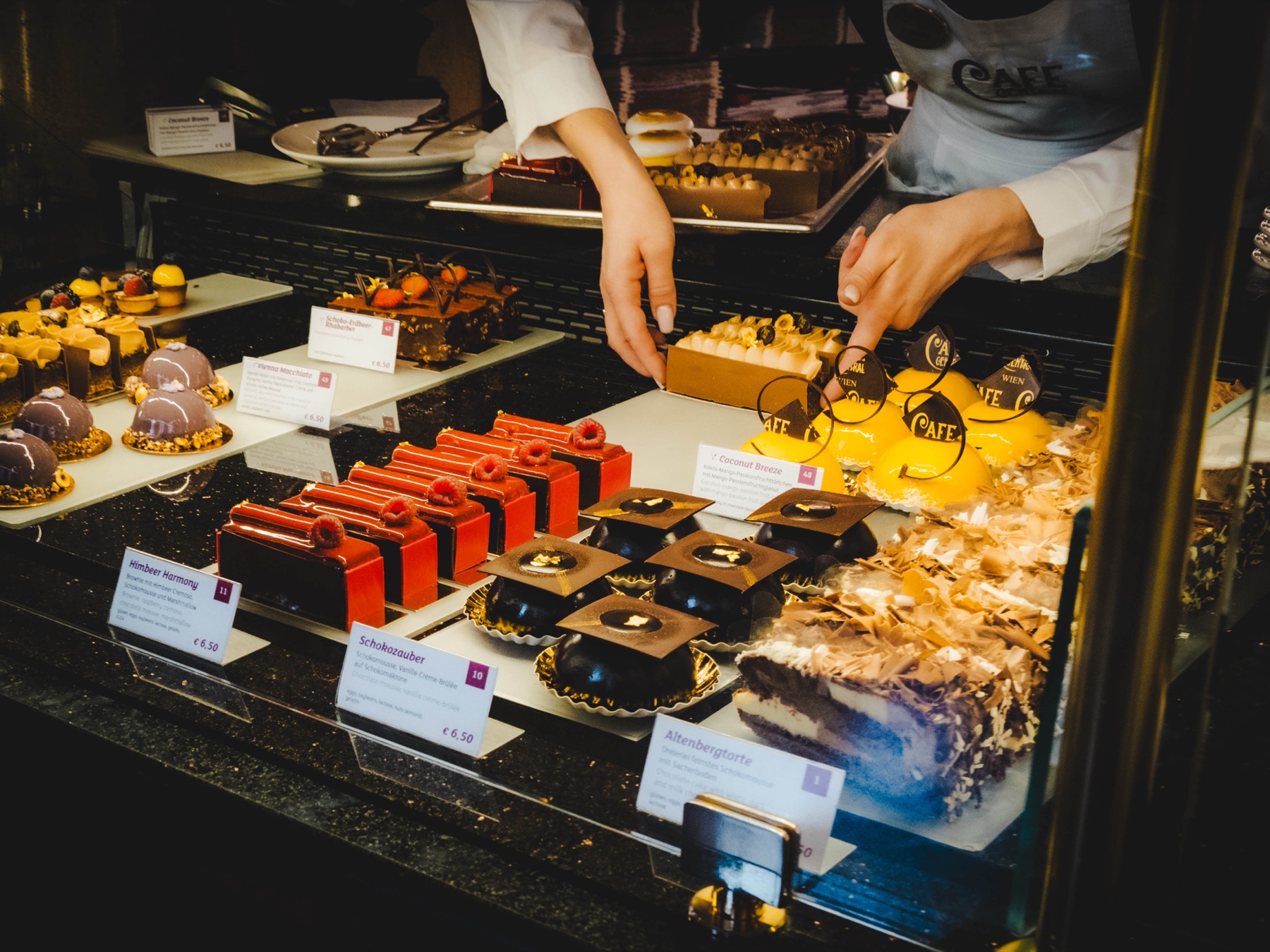 Small sweets lined up across a glowing market counter