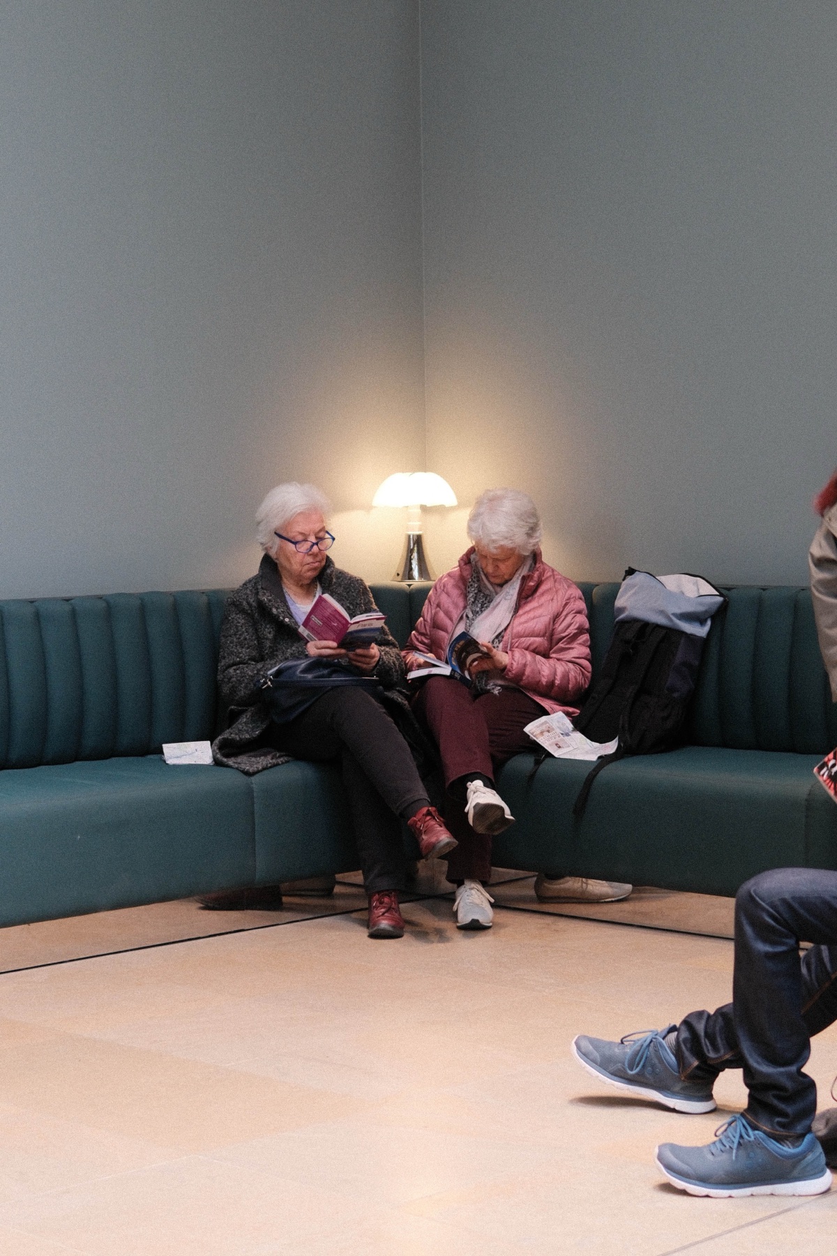 Two women reading in a quiet departure lounge