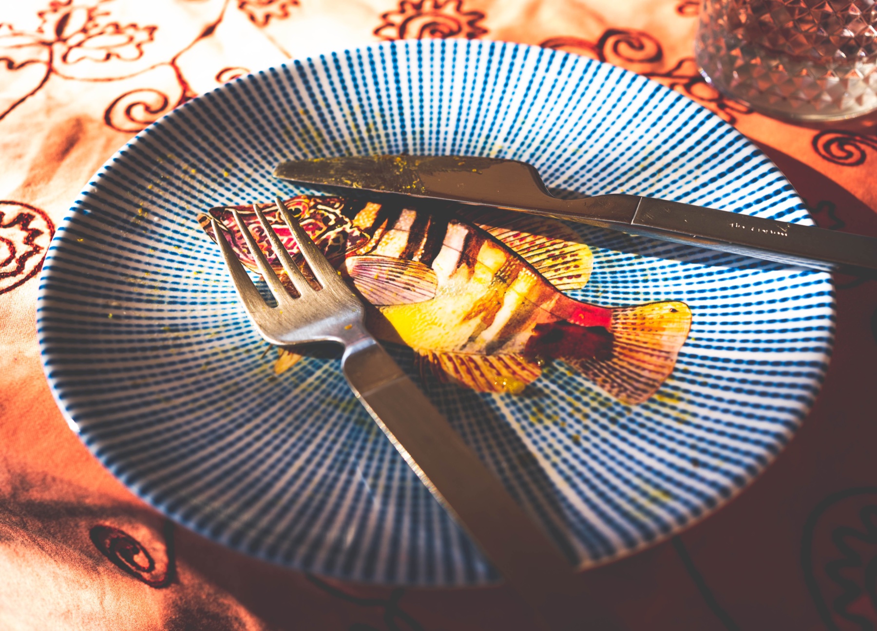 A vivid blue dinner plate beneath warm light