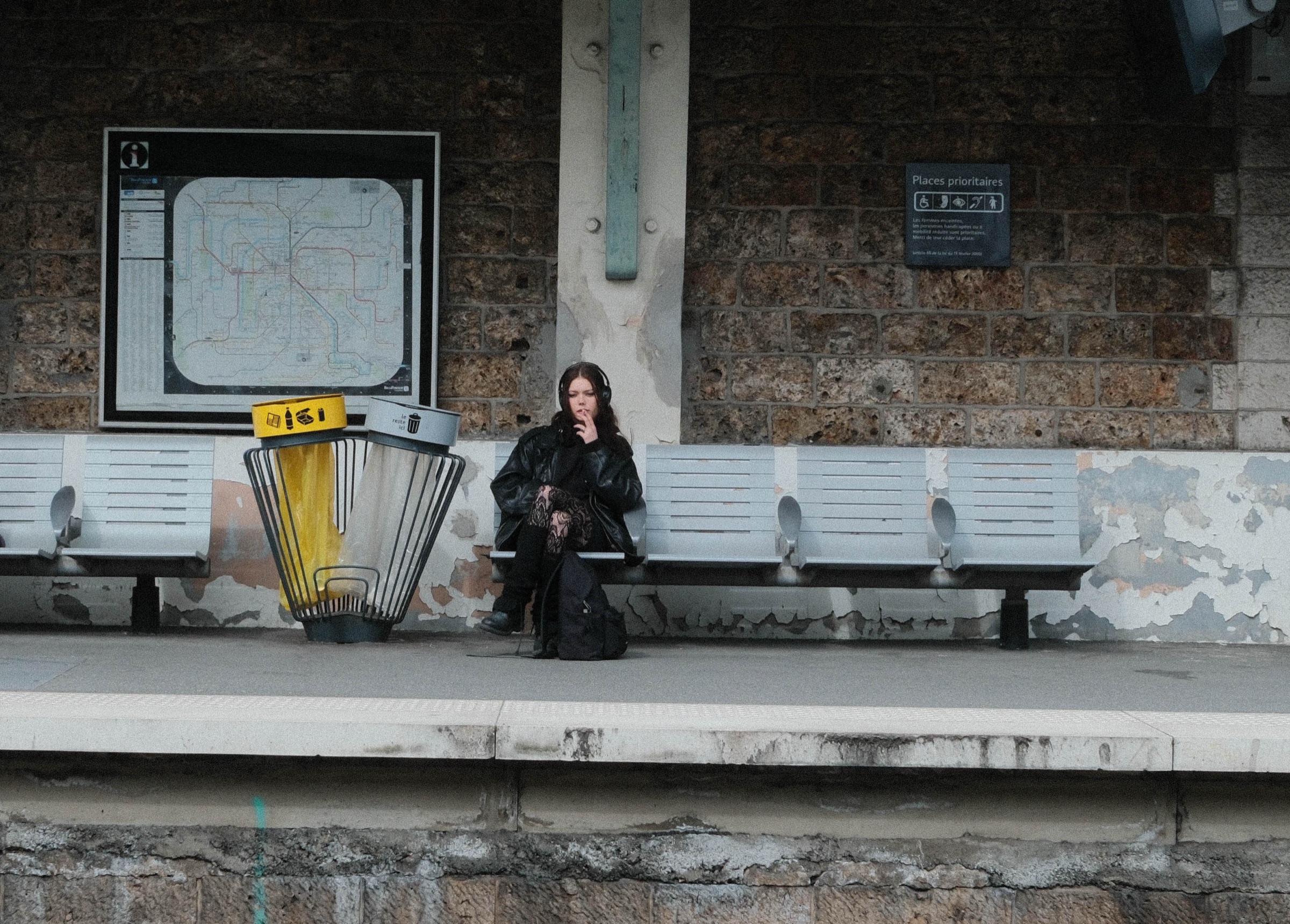 A person waiting alone on a weathered railway platform