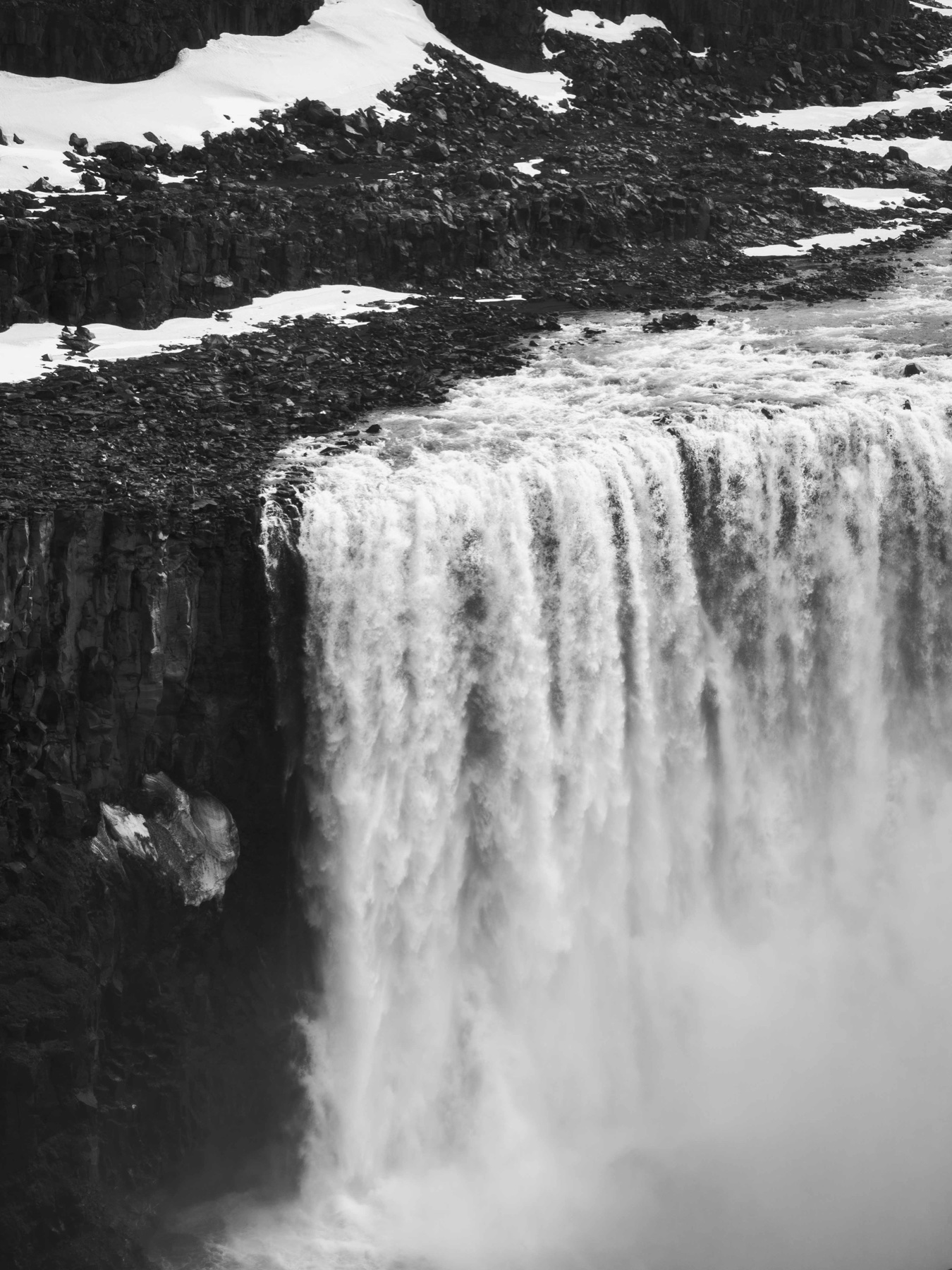 A broad waterfall dropping into deep shadow